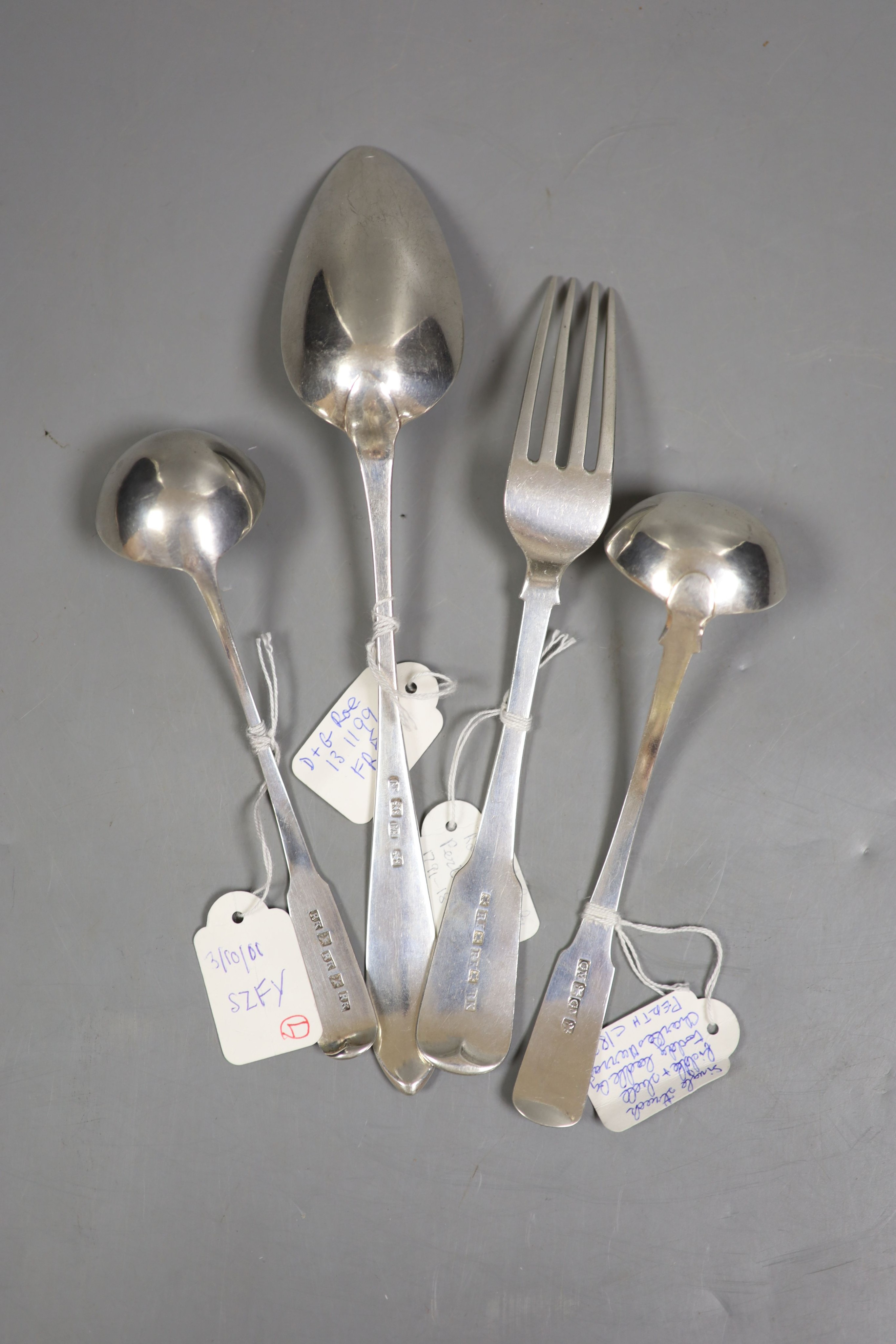 A 19th century Scottish provincial silver Celtic tip tablespoon, 23.5cm, c.1790, a fiddle pattern table fork and fiddle pattern toddy ladle, by Robert Keay, Perth, c.1830 and a fiddle and shall pattern toddy ladle, Charl